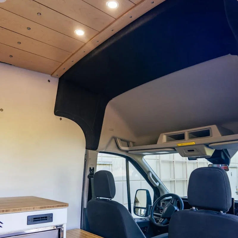 GoCode black fabric B-pillar trim panel installed in a Ford Transit high roof camper van interior.