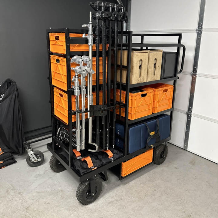 Full size SidioCrate black metal storage rack with orange bins and equipment organizers on wheels