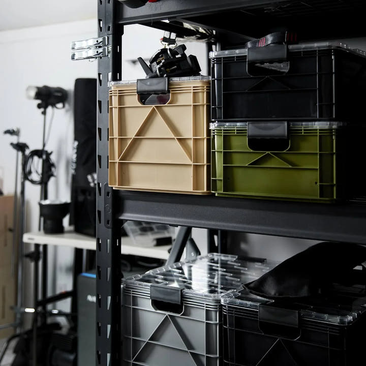 Tan and olive green SidioCrate storage bins on a black metal shelving unit.